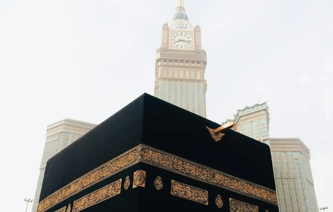 The Kaaba in Makkah with the Makkah Clock Tower behind it, where pilgrims make dua before travelling home to the UK